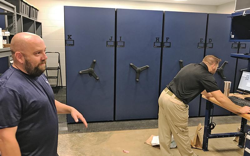 Cornelia Assistant Police Chief Jonathon Roberts (left) and Lt. Kevin Marsteller were excited to show off the new evidence room for the one and only time ever during Wednesday’s move-in.