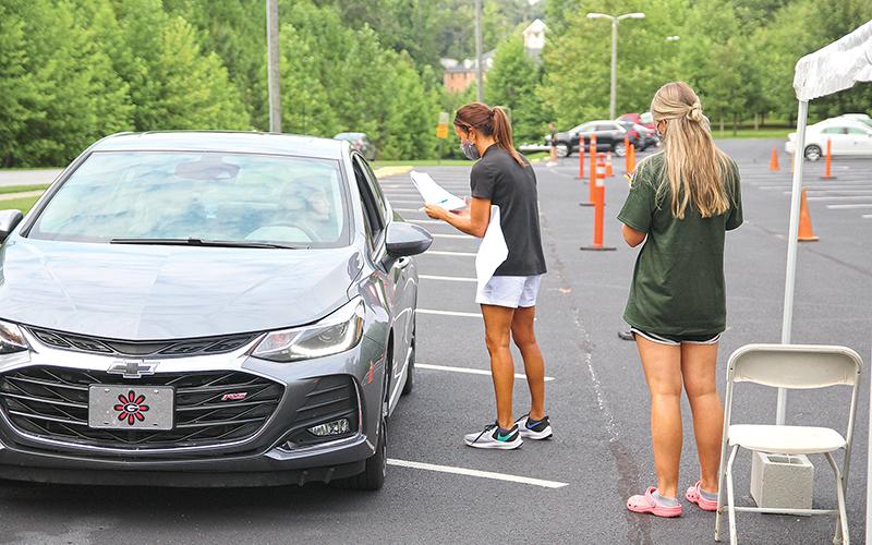 Piedmont College students moving into campus (and people helping them) have to successfully pass a health screening as they did Thursday near the Arrendale Amphitheater.