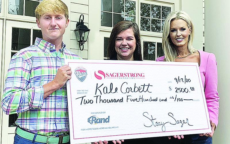 Kale Corbett  receives a check for $2,500 scholarship in addition to being named the 2020 SagerStrong Foundation Hometown Hero. To Corbett’s right are Randi Minor, Principal at Rand Refrigeration and Stacey Sager, President of the SagerStrong Foundation.
