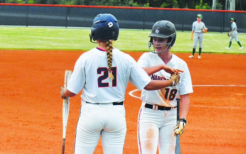 Habersham Central’s Taylor Wade and Preslee Hix celebrate a run against Buford on Sept. 16. CODY ROGERS/Staff
