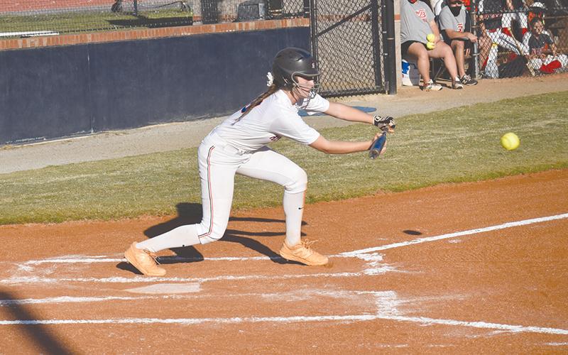 Taylor Wade lays down a bunt for a hit Monday’s win over Winder-Barrow. Wade reached base four times and scored three runs for the Lady Raiders.