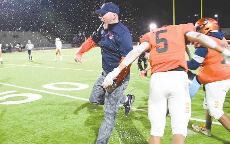 Habersham Central coach Benji Harrison celebrates after having Gatorade poured on him following the Raiders' win over Lanier. TOM ASKEW/Special