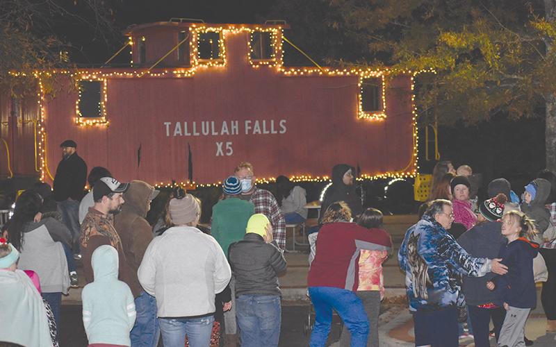 The holiday goers spilled out to the Cornelia Train Depot to see Santa Claus and hitch up for a hayride.