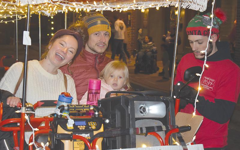Jessica and Chris Gneiding took their little ones Anneliese (shown) and Lucas on the pedal cart at the Downtown Christmas event in Cornelia on Saturday.