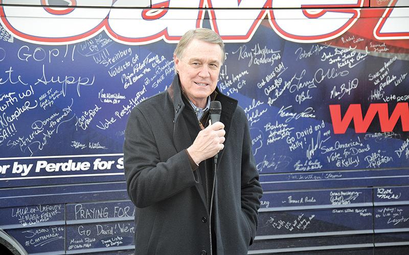 U.S. Sen. David Perdue chats with folks in Cornelia on his bus tour of Georgia leading up to the runoff election on Jan. 5.