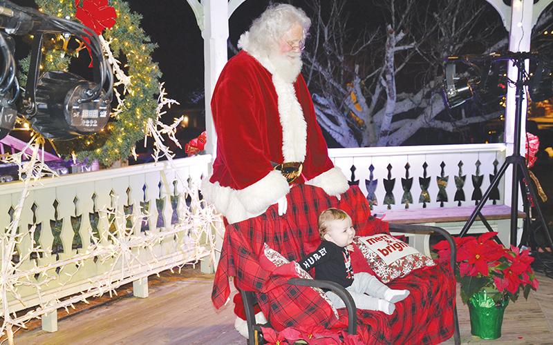 Santa visits with 10-month-old Braylon Head at Downtown Clarkesville Christmas.