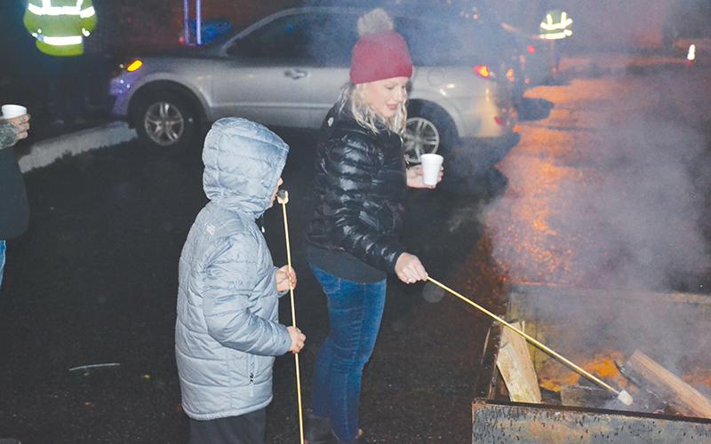 Angie Lance and Chandler Dale toast marshmallows in Clarkesville on Saturday night.
