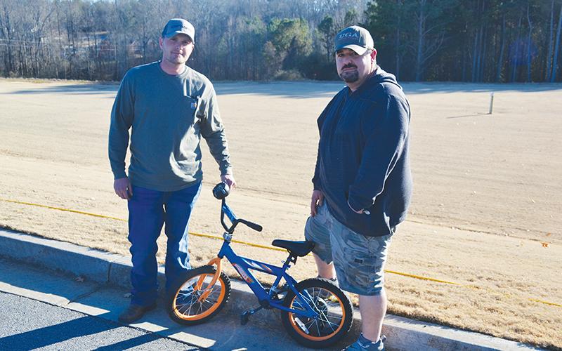 Jarrod Seabolt (left) and Mikel Bramblett have provided 26 repaired bicycles to children this Christmas as part of Drug Court’s requirements to give back to the community, but they plan to keep giving beyond completion of the program.