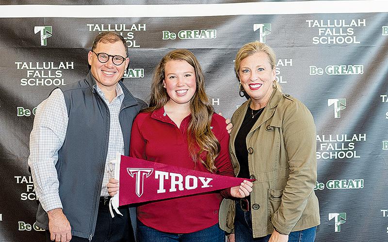 Brinson Hall (center) signed a letter of intent to continue her golf career at Troy University with her parents Stacy (left) and Ivy Hall (right) by her side. Hall is the third Indian to sign a D-I scholarship this year, joining classmates Maggie Jackson (Wofford, golf) and Katy Corbett (Mercer, volleyball). Photo by BRIAN CARTER/Submitted