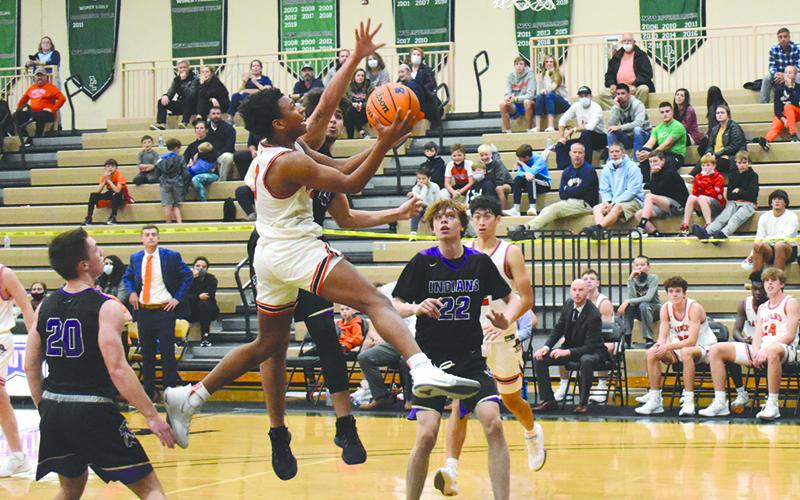 Malachi Dooley looks to finish over a defender in the Raiders’ season-opener against Lumpkin County. Dooley led HCHS Tuesday night with 31 points in the double-overtime victory that got the Raiders off to their first 4-1 start since 2011-12.