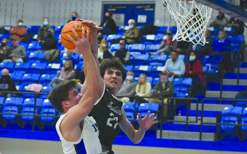 Tallulah Falls’ Gabe Keene challenges Towns County big man Jake McTaggart at the rim during their game Dec. 3.