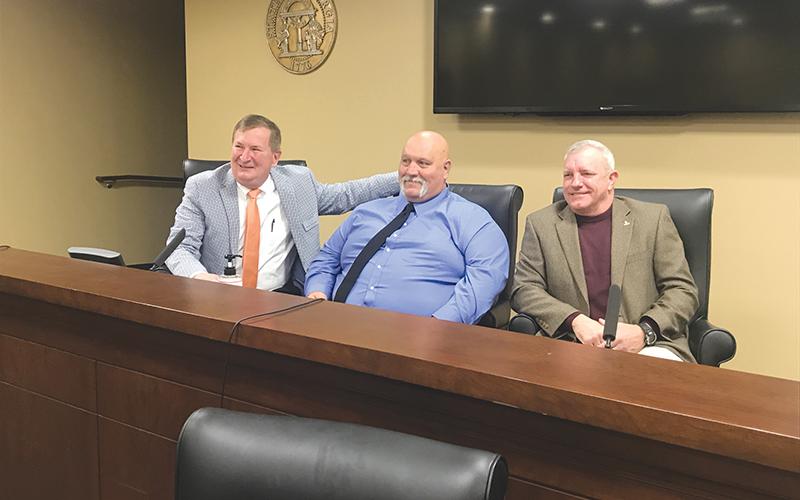 Newly-sworn in Habersham County Commissioners (from left) Bruce Harkness, Bruce Palmer and Tim Stamey visit briefly after signing their paperwork to begin their four-year terms.