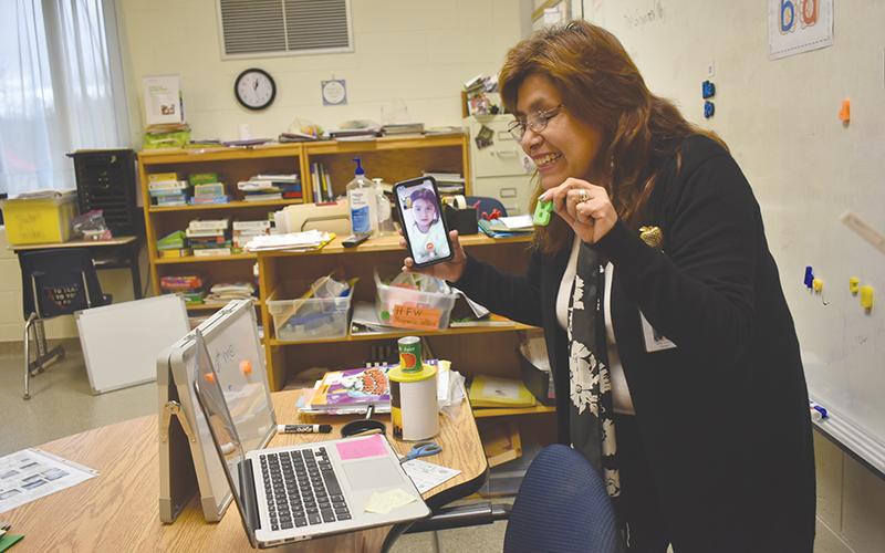 ESOL teacher Silvia Corwin praises her virtual kindergarten class Thursday for correctly identifying the letter “B” in English. On the phone is Marilu Manuel, whose parents don’t know how to log onto Google Classroom. Corwin accommodates with a video call.