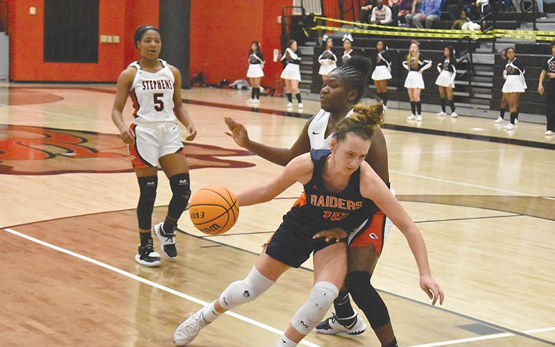 Habersham  Central’s Taylor Wade drives inside against a Stephens County defender during Tuesday night’s game in Toccoa.