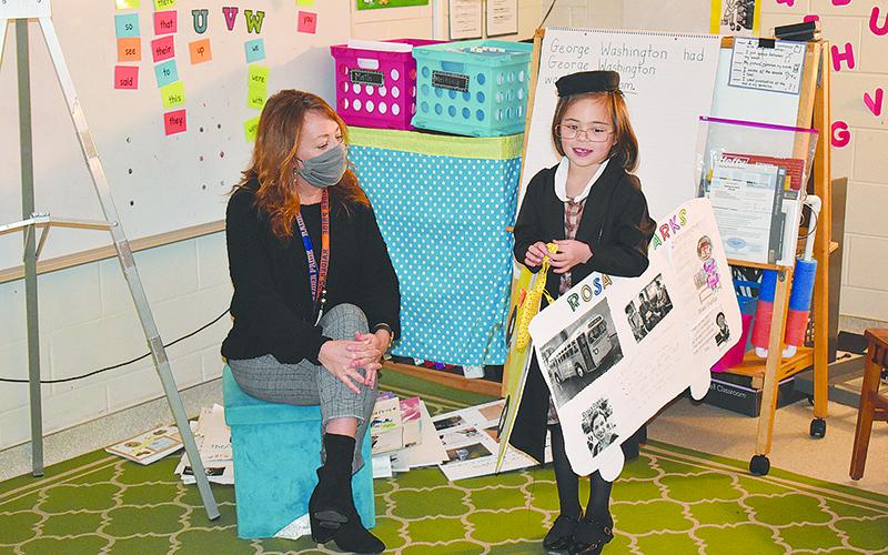 Cornelia Elementary student Evie Alexander presents her project about Rosa Parks as teacher Melissa Sedwick listens on Friday morning.