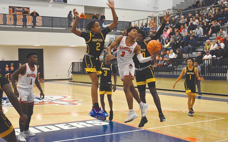 Malachi Dooley finishes between two defenders last Friday night against Central Gwinnett. The Raiders needed Dooley’s heroics down the stretch again in Tuesday night’s rematch, as he hit the game-winner at the buzzer.