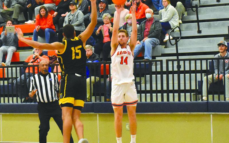 Habersham Central’s Grant Tipton launches a 3-pointer over Central Gwinnett’s Osiris Shabazz on Friday night.