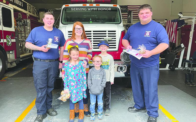 Megan Creel and her children Camden, Rylie and Wyatt brought cookies to the Demorest Fire Department on Monday. Receiving the treats are firefighters Michael Hall (left) and Jonathan Knight.