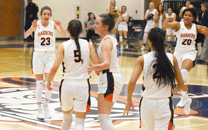 Habersham Central's girls basketball players (from left) Kyia Barrett, Addie Penick (5),  Taylor Wade, Liz Pollitt and Nyke Brown celebrate a 3-pointer by Penick in the opening round of the state playoffs. Penick was fouled and went on to convert a four-point play.