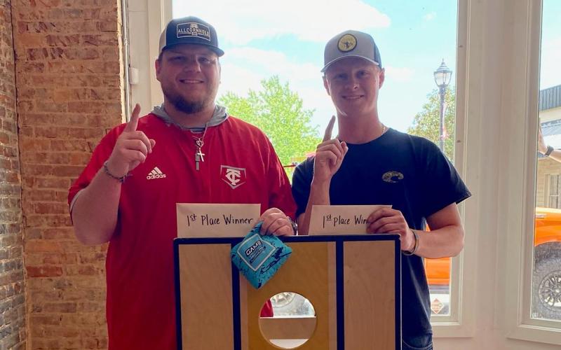Chase Phillips (left) and Brady Tanner took first place in the Cornelia DDA’s cornhole tournament. The winners received a pair of $100 Visa gift cards and $50 Bigg Daddys gift cards. LINDSEY FITZGERALD/Submitted