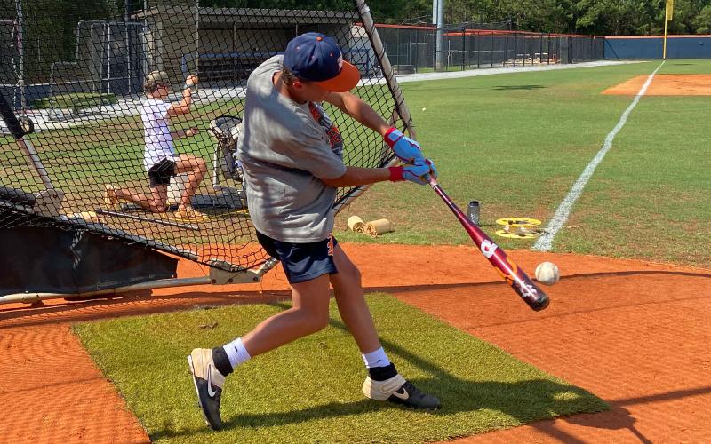 Konner Burrell puts a swing on a ball to test his exit velocity and launch angle during Monday’s practice. ISAIAH SMITH/Staff