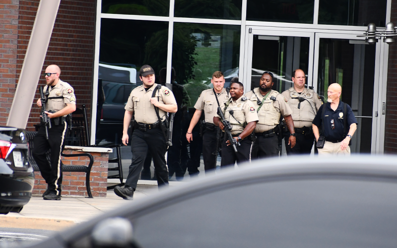 Habersham County Sheriff’s deputies leave the Visual Technology Center building Monday afternoon upon clearing the building of explosives. MATTHEW OSBORNE/Staff