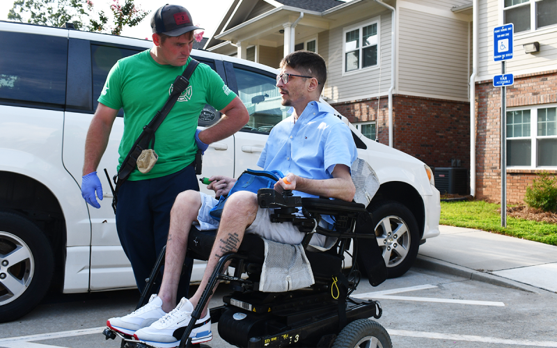 Russell Gregory speaks with Cornelia  Firefighter Drake Meister prior to being transported for injuries he says he sustained due to lack of care over the weekend. BRIAN WELLMEIER/Staff