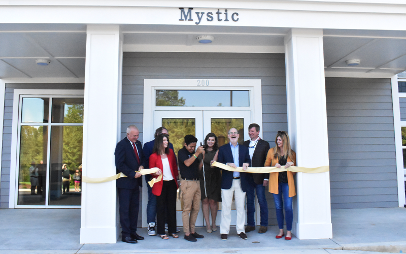 Bruce Willis, Nick Kastner, Kim Crawford, Leonardo Galarza, Madison Smith, James Mellichamp, Jerry Harness, and Mary Beth Horton gathered to celebrate the official opening of Piedmont Universities’ newest residence hall, Mystic Hall, during the special ribbon-cutting celebration on Friday. AMARIS E. RODRIGUEZ/Staff