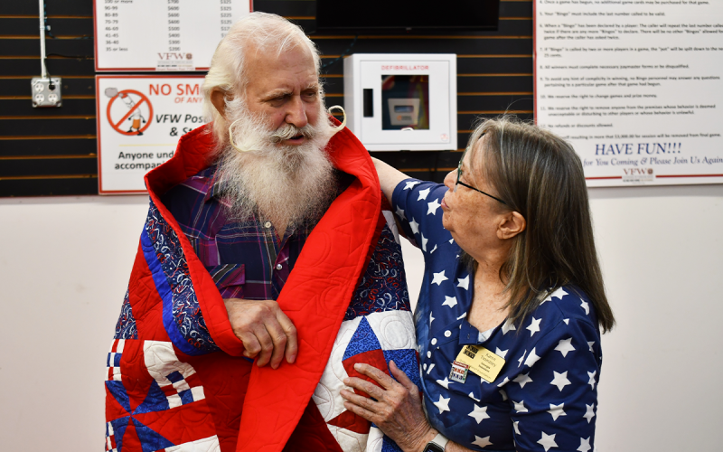 Karen Trombley shares an embrace with Clarence G. Mason after he received his Quilt of Honor along with 10 other veterans on Saturday. MATTHEW OSBORNE/Staff