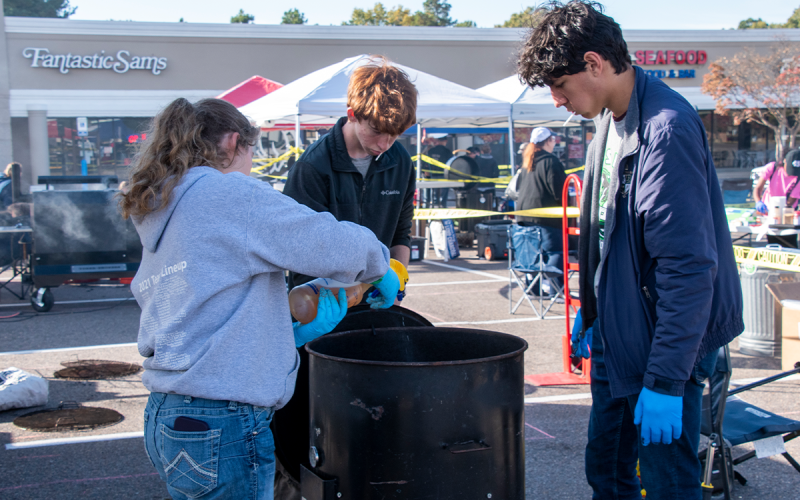 Brooke Hayes, Matthew Wolfe and Marc Crotta work on their barbecue in a 55-gallon drum at the World Jr. BBQ Championships. SASSY HAYES/Submitted 