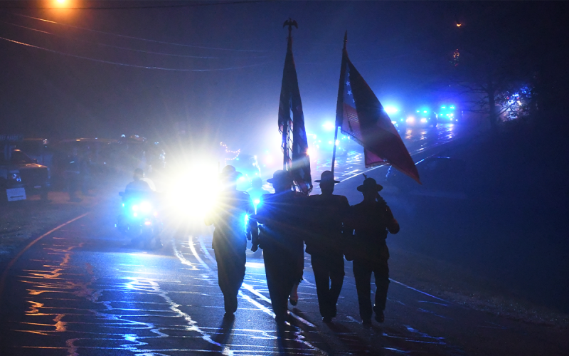 Officers from Georgia State Patrol’s Honor Guard lead a massive contingent of law enforcement vehicles through the fog on Tuesday night. MATTHEW OSBORNE/Staff