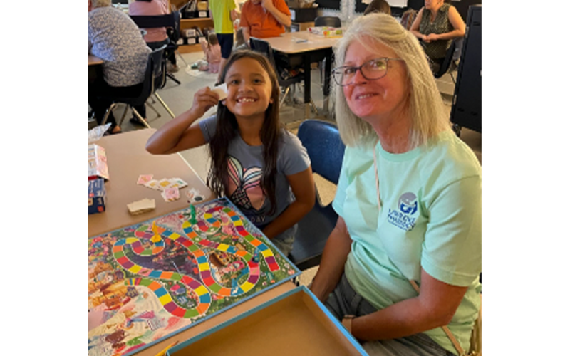 Level Grove third grade student Coralie Phasavang plays Candy Land with her Mimi, Diane Springer.  SUSAN DAVIS/Submitted