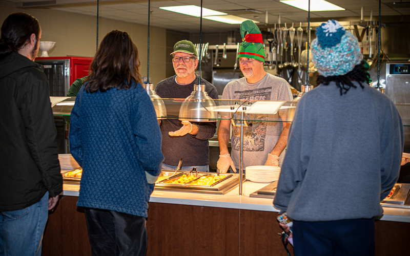 Students line up to be served by Campus Minister Tim Garvin-Leighton, left, and Lillian E. Smith Center Director Dr. Matthew Teutsch during Piedmont University’s Late-Night Breakfast. RACHEL PLEASANT/Submitted