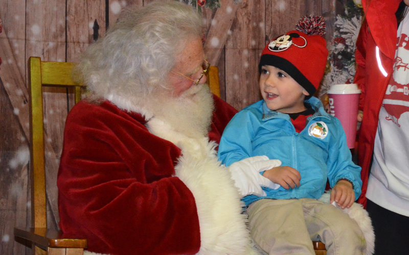 Tucker Fields tells Santa Claus what he wants for Christmas this year. SAMANTHA SINCLAIR/ CNI News Service