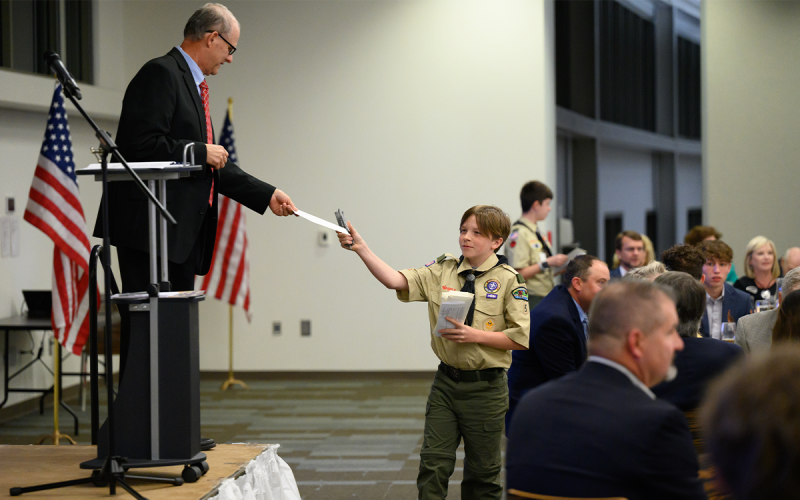 Foy Todd hands his donation to The Boy Scouts of America to Troop 5 scout Thatcher Tatum (right). The Habersham American Values Dinner raised $71,880 for Boy Scouts across Northeast Georgia.  ZACH TAYLOR/Special