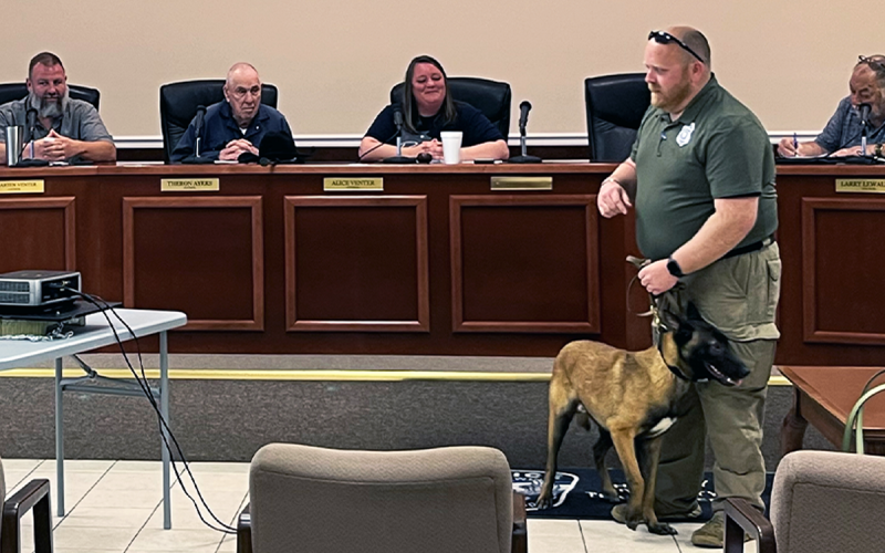 Baldwin Assistant Police Chief Justin Ferguson and the newly-minted Nikos present to the Baldwin City Council on Tuesday night. JOHN DILLS/Staff