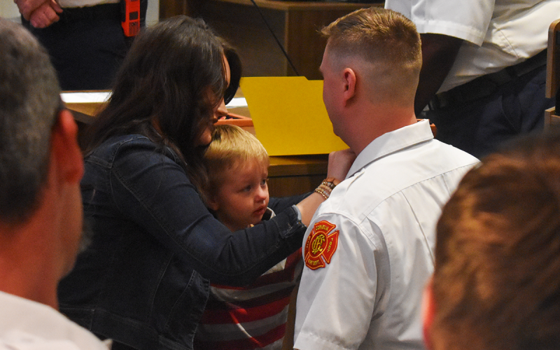 Lt. Christopher Bruce is pinned by his wife, Ashley, and their sons Liam and Cason. EMMA MARTI/Staff