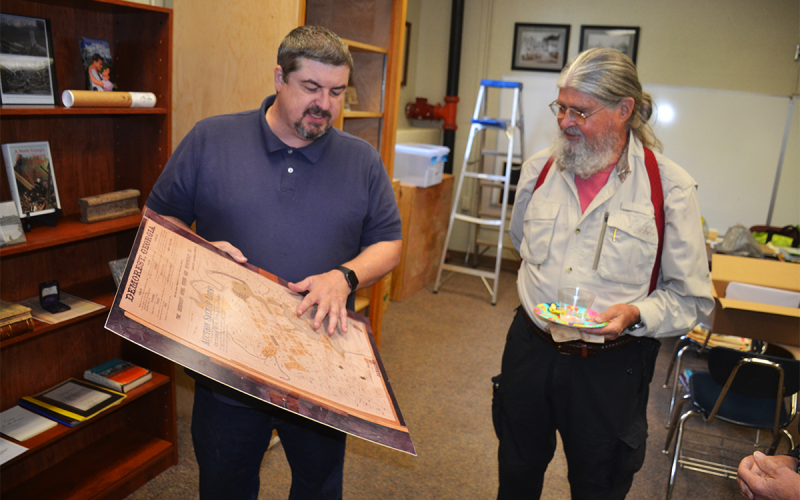 Demorest Councilman Shawn Allen shows a land plat from the 1890s to Dr. Rick Gadbois at Monday’s open house at Demorest City Hall. MATTHEW OSBORNE/Staff
