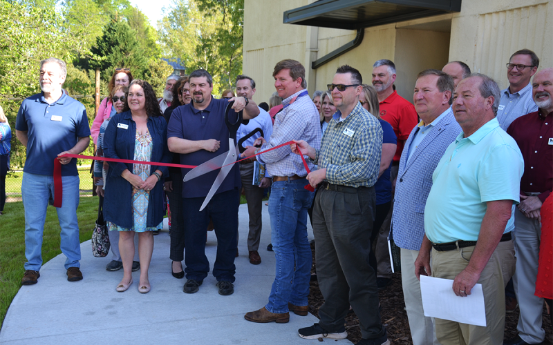 Officials cut the ribbon at Demorest City Hall, including (from left) Chamber of Commerce Ambassador Guy Ramos, Chamber President Elle Van Doorum, Councilman Shawn Allen, Mayor Jerry Harkness, Chamber Ambassador Randall Roy Fry, County Commissioner Bruce Harkness and City Manager Mark Musselwhite, along with many well wishers and community members. MATTHEW OSBORNE/Staff