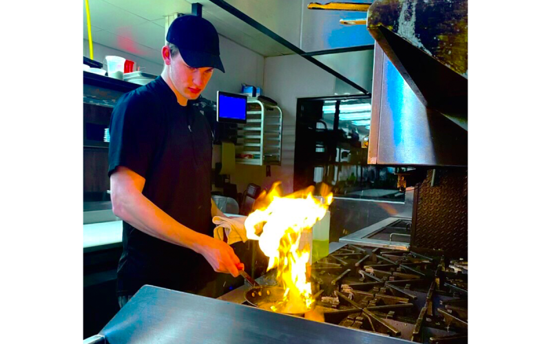 Jace Reeder gets his dish going during one of his shifts at Community Brew & Tap in Cornelia. Reeder also cooks at Fenders Diner. SUBMITTED