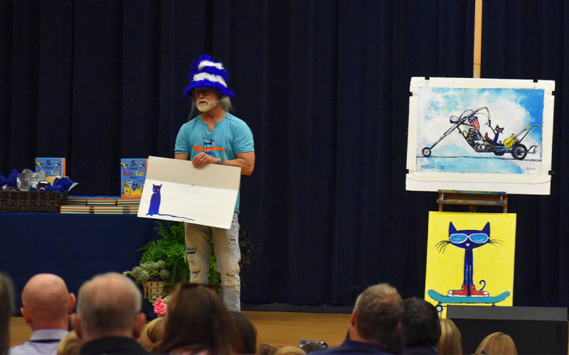 James Dean, author of the children’s book series “Pete the Cat,” shows the audience the original drawing of his cat Pete, which evolved into the character children and adults alike know and love. EMMA MARTI/Staff