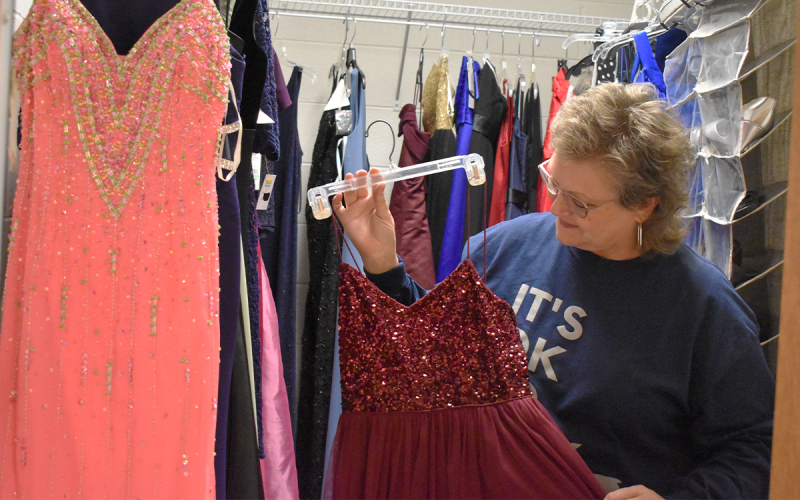 Donna Barrett shows off one of the dresses donated to the Prom Dress Closet at the Habersham Ninth Grade Academy. EMMA MARTI/Staff