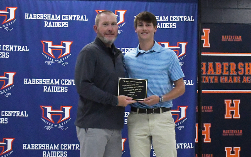 Slade Dover (right) got the Courage Award from Raiders head coach Benji Harrison. LANG STOREY/Staff