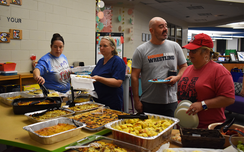 From left, Fairview Elementary employees Holly Whiteman, Wendee Thomas, Len King and Carrie Davis grab some breakfast before starting their day. EMMA MARTI/Staff