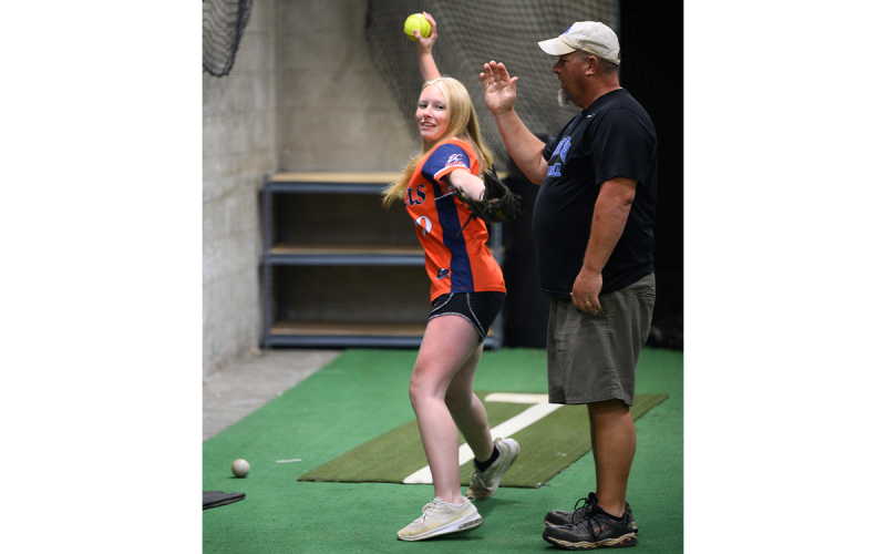 Nick Denton, a pitching and hitting instructor at Velo Factory, instructs Ava Buffington (left) to not hit his arm in a cross-body pitching drill for changeups. ZACH TAYLOR/Special