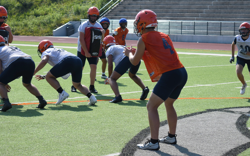 Starting quarterback Carson Parker does the same during another practice play Thursday. LANG STOREY/Staff