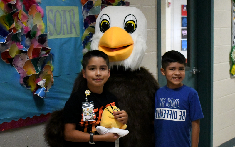 Jaydee and Oliver Paramo are greeted by Baldwin Elementary School’s eagle mascot. JOHN DILLS/Staff