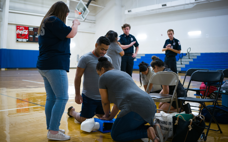 Juan and Marichal Soranny practice CPR while Katy Dyke gives some helpful pointers on hand placement. ZACH TAYLOR/Special