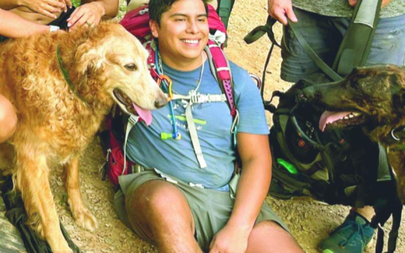 Bryan Santana and Prince are happy to have safely reached the end of their hike with help from some new friends. SUBMITTED