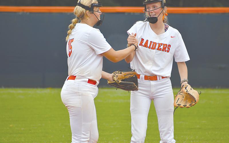 Habersham Central’s Hailee Parham (left) and Karsen Wade pump each other up before the inning begins. LANG STOREY/Staff